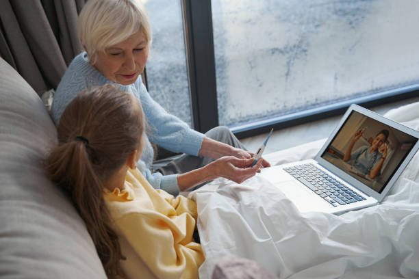 Distressed grandma using Internet to get medical help for kid stock photo