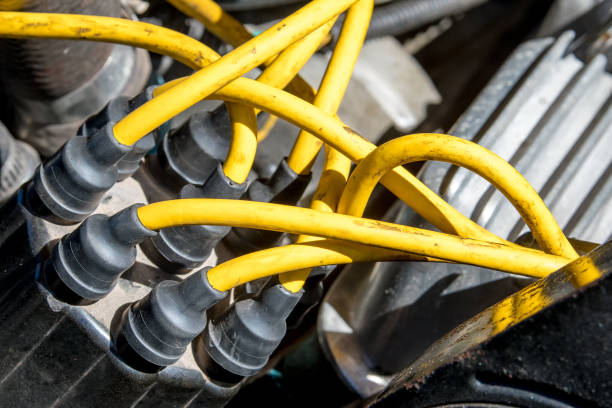 Distributor Cap With Orange Wires Distributor cap and high performance yellow ignition wires on a car engine. ignition stock pictures, royalty-free photos & images