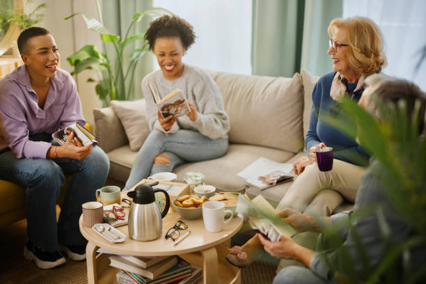Diverse group of friends discussing a book stock photo