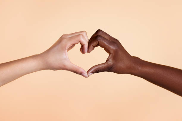 Diverse hands with love sign on beige background