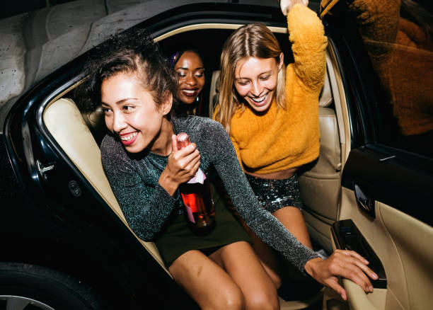 Diverse women in a backseat of a cab Diverse women in a backseat of a cab back seat stock pictures, royalty-free photos & images