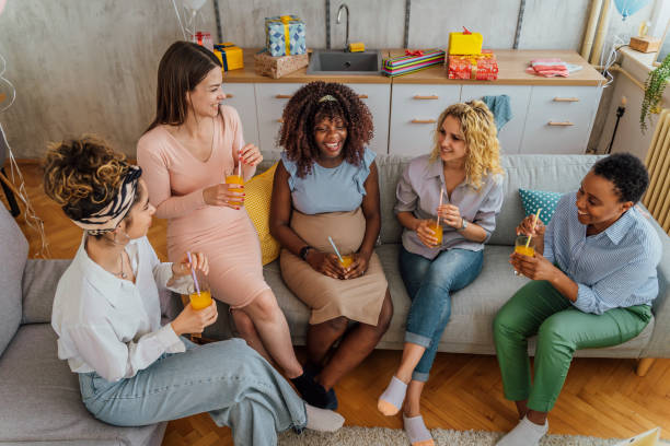 Diverse women together at baby shower stock photo