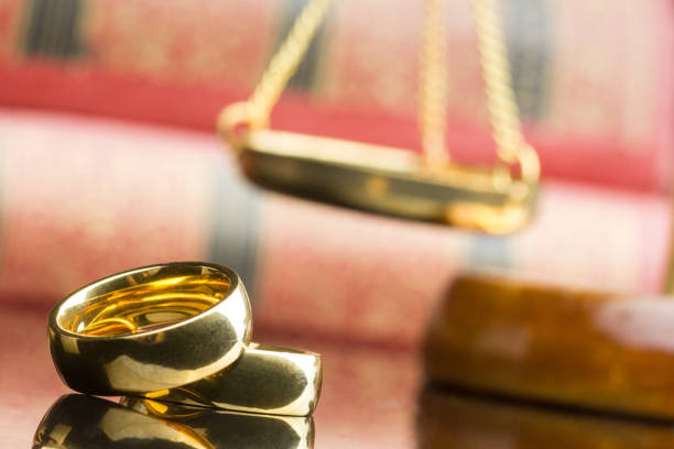 Divorce and separation concept. Two golden wedding rings and judge gavel stock photo