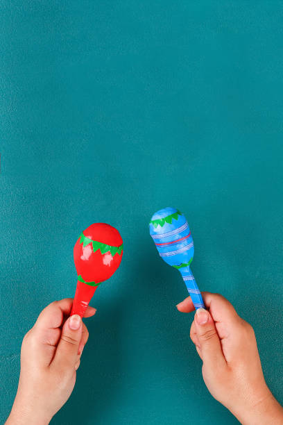 Diy cinco de mayo maracas from eggs, spoons and cereals on a green background. stock photo