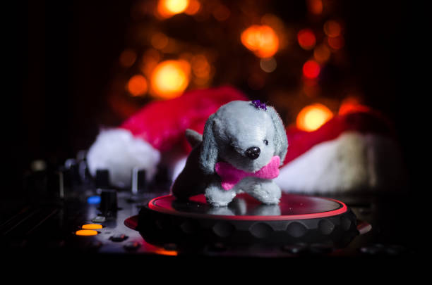 Dj mixer with headphones on dark nightclub background with Christmas...
