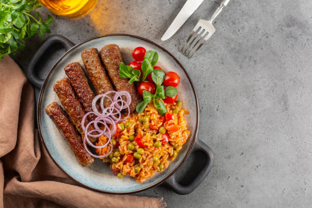 Djuvec rice and beef cevapcici - dish from South-Eastern Europe. stock photo