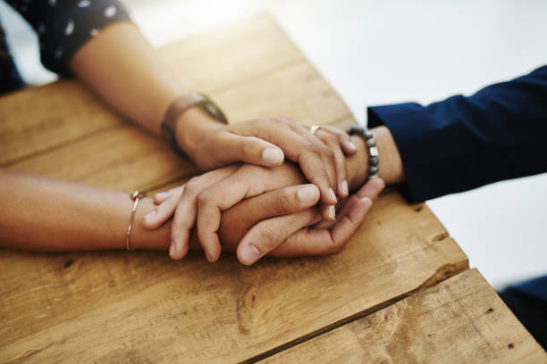 Do for others what you want done for you Closeup shot of two unrecognizable people holding hands in comfort support stock pictures, royalty-free photos & images