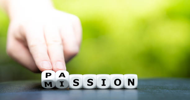 Do your mission with passion. Hand turns dice and changes the name "mission" to "passion". stock photo