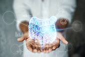 istock Doctor and holographic bowel scan projection with vital signs and medical records. Concept of new technologies, body scan, digital x-ray, abdominal organs, modern medicine. 1313152158