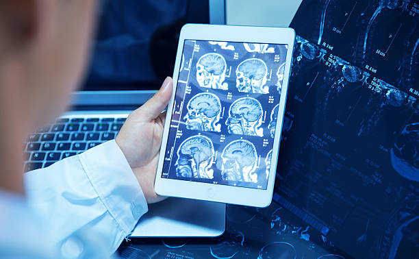 doctor checking x ray with tablet doctor checking x ray with tablet x ray photograph stock pictures, royalty-free photos & images