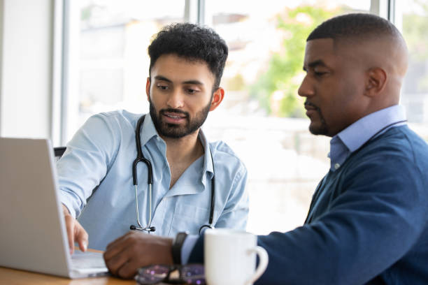 Doctor consulting with colleague or patient stock photo