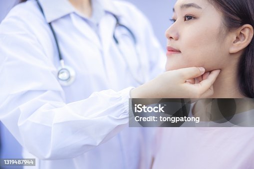 istock Doctor examination the back and neck of a women patient outdoor 1319487944