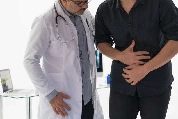 Doctor examining abdomen of patient Doctor examining abdomen of patient stomachache stock pictures, royalty-free photos & images