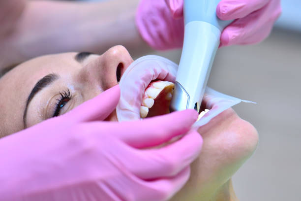 Doctor examining patient teeth with intraoral 3d scanner. stock photo