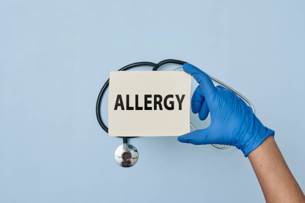 Doctor hand holds a card with allergy sign Doctor hand holds a card with allergy sign. Hand in medical gloves holding a white card with text - allergy. Concept of allergy check-up, medical exam allergy test stock pictures, royalty-free photos & images