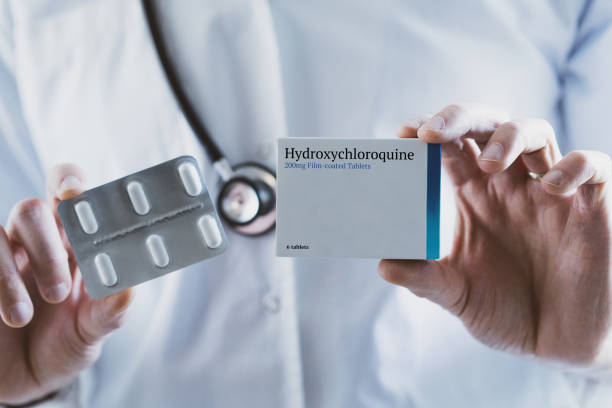 Doctor holding Hydroxychloroquine drug stock photo