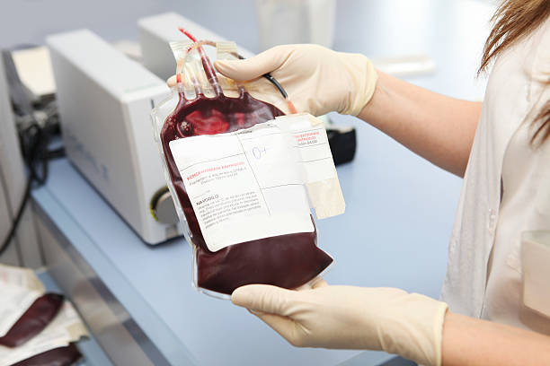 Doctor in a blood bank holding  bag  with red cells stock photo