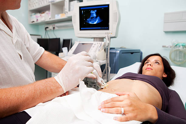 Doctor is performing liver biopsy to women...supporting with Ultrasound stock photo