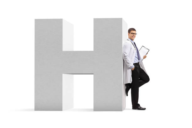 doctor leaning on a letter h, a sign for hospital - doctor wall imagens e fotografias de stock