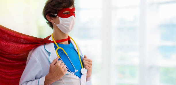 Doctor or nurse in face mask and superhero cape. Doctor or nurse wearing surgical face mask in superhero cape. Medical staff during coronavirus outbreak. Super hero power for clinic and hospital personal. nurse face stock pictures, royalty-free photos & images