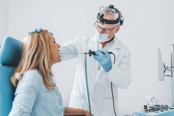 Doctor otolaryngologist making endoscopic examination of oral cavity for female patient at office Doctor otolaryngologist making endoscopic examination of oral cavity for female patient at office oral problems stock pictures, royalty-free photos & images