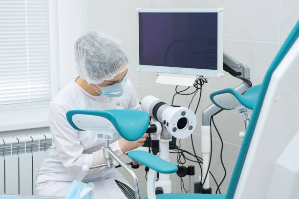 doctor prepares the colposcope before the patient arrives stock photo
