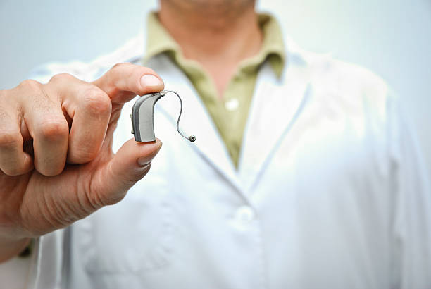 doctor showing hearing aid - hearing aid stok fotoğraflar ve resimler