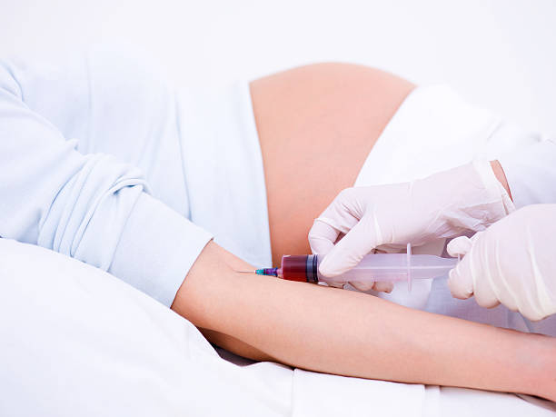Doctor takes blood on the analysis Doctor takes blood on the analysis from the pregnant woman pregnant blood test stock pictures, royalty-free photos & images