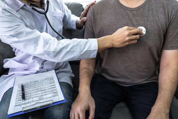 Doctor using a stethoscope checking patient about the problem of illness, sickness condition and recommend with examining treatment method stock photo