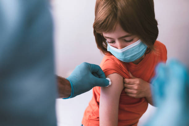 Doctor vaccinating a child stock photo