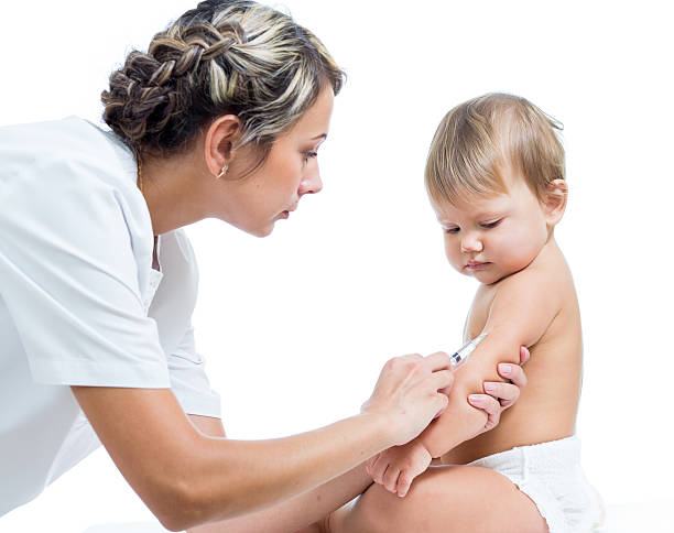 doctor vaccinating  baby girl over white background stock photo