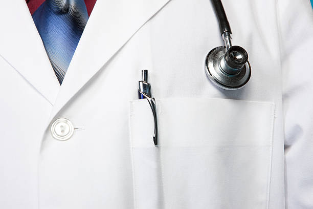 Doctor wearing white lab coat with stethoscope on their neck stock photo