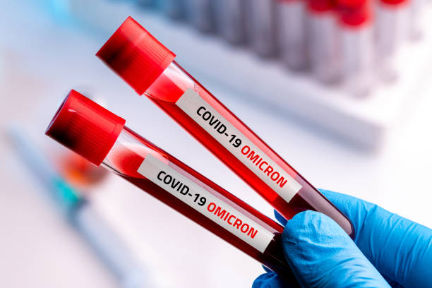 doctor with blood sample of covid-19 omicron b.1.1.529 variant and general data of covid-19 coronavirus mutations. - omicron stockfoto's en -beelden