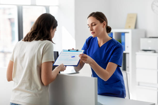 doctor with clipboard and patient at hospital stock photo