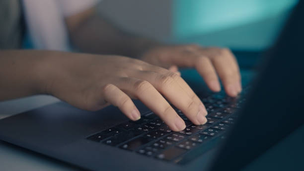 Doctor's hand typing on laptop stock photo