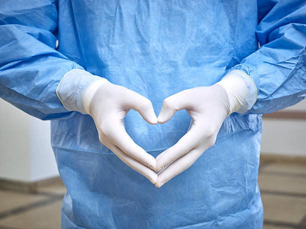 Doctor's hands forming a heart shape stock photo
