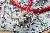 istock Doctors medical stethoscope on money background healthcare expensive concept 1351105760