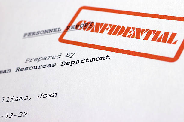 A document stamped with the word confidential stock photo