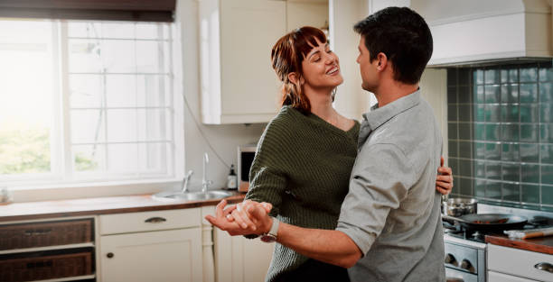 Beautiful Couple Slow Dancing In The Kitchen Stock Photos, Pictures