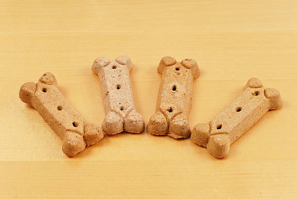 Doggy Snacks 4 Doggy Bone Puppy Snacks on wood floor for animal feed and snack ideas chewy stock pictures, royalty-free photos & images