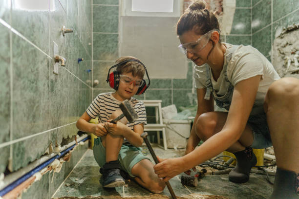 Doing housing project together Photo of a mother and her young son, doing a housing project together bathroom DIY stock pictures, royalty-free photos & images