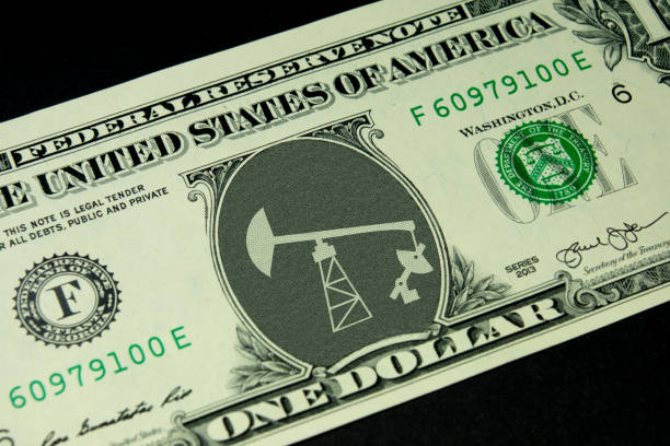 Dollar and a crude oil rig stock photo