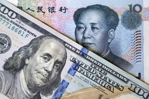 US dollar and chinese yuan notes Concept of trade war between China and USA, economic sanctions, trading and investment bond market  stock pictures, royalty-free photos & images