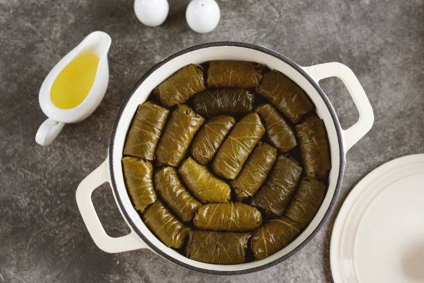Dolma (tolma, sarma) - stuffed grape leaves with minced meat, rice, onion and carrot. Traditional Greek, Turkish, Ottoman and Caucasian cuisine. stock photo