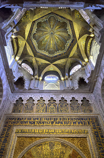 Dome of ancient mosque on the inside A dome of the ancient mosque has blue tiles decorated with stars. La Mezquita Cathedral is regarded as the one of the most accomplished monuments of Islamic architecture. cordoba mosque stock pictures, royalty-free photos & images