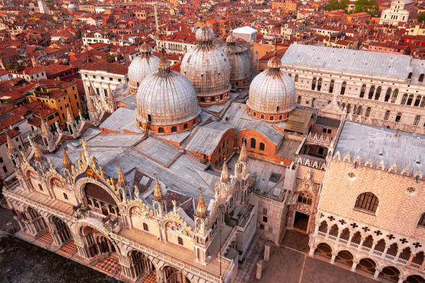 Domes of St. Mark's Basilica, Venice, Italy aerial view of Saint Mark's Basilica and city roofs, Venice, Italy basilica stock pictures, royalty-free photos & images