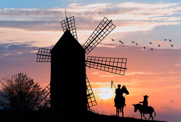 don quijote and sancho panza at the windmills in sunset - cargo canarias imagens e fotografias de stock