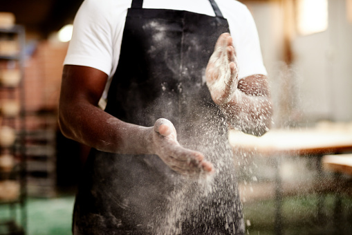 Cropped shot of an unrecognizable male baker dusting the flour off his hands