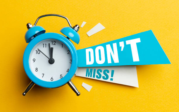 Don't Miss Alarm clock and colour papers on the white background. failure stock pictures, royalty-free photos & images