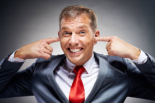 I don't want to hear it! Politician with fingers in his ears Fingers in Ears stock pictures, royalty-free photos & images